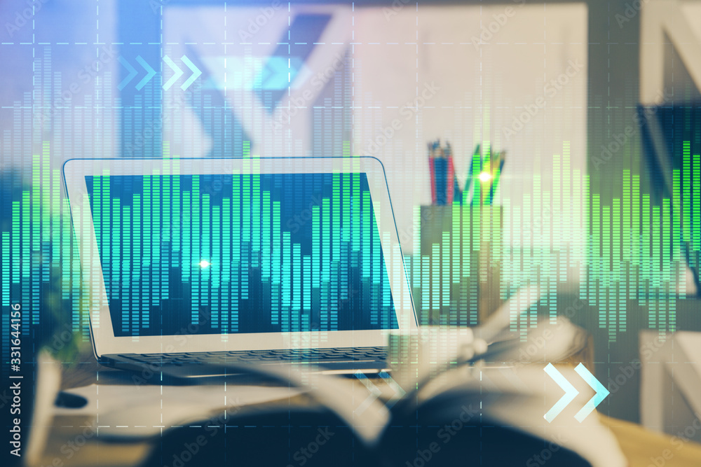 Financial graph colorful drawing and table with computer on background. Multi exposure. Concept of international markets. Financial graph colorful drawing and table with computer on background. Multi exposure. Concept of international markets.
