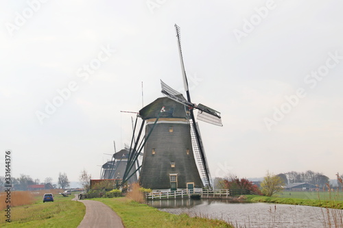 Three windmills in a row in the Driemanspolder at Stompwijk the Netherlands photo