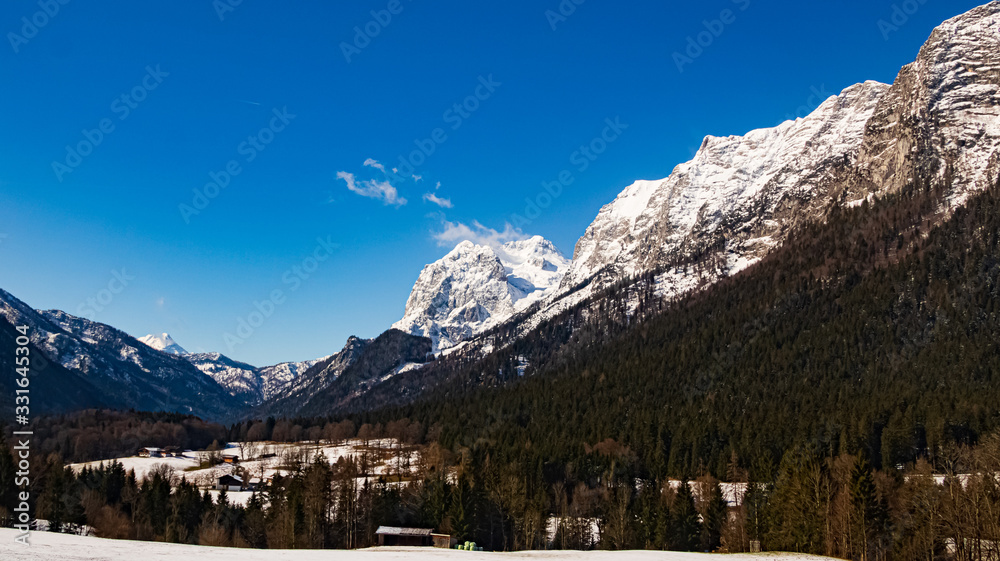 Beautiful winter landscape with mountains in the background near Ramsau, Berchtesgaden, Bavaria, Germany