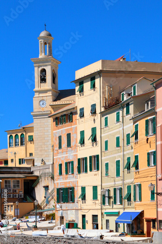 colored apartment buildings and church in genova boccadasse in italy