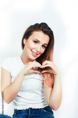 young pretty teenage hipster girl posing emotional happy smiling on white background, lifestyle people concept