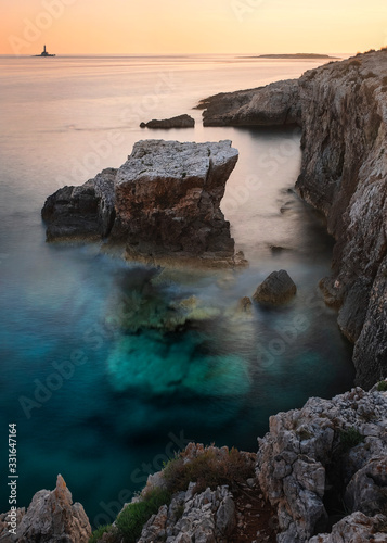 Long exposure of the Croatian sea and a rock close to Premantura, Croatia photo