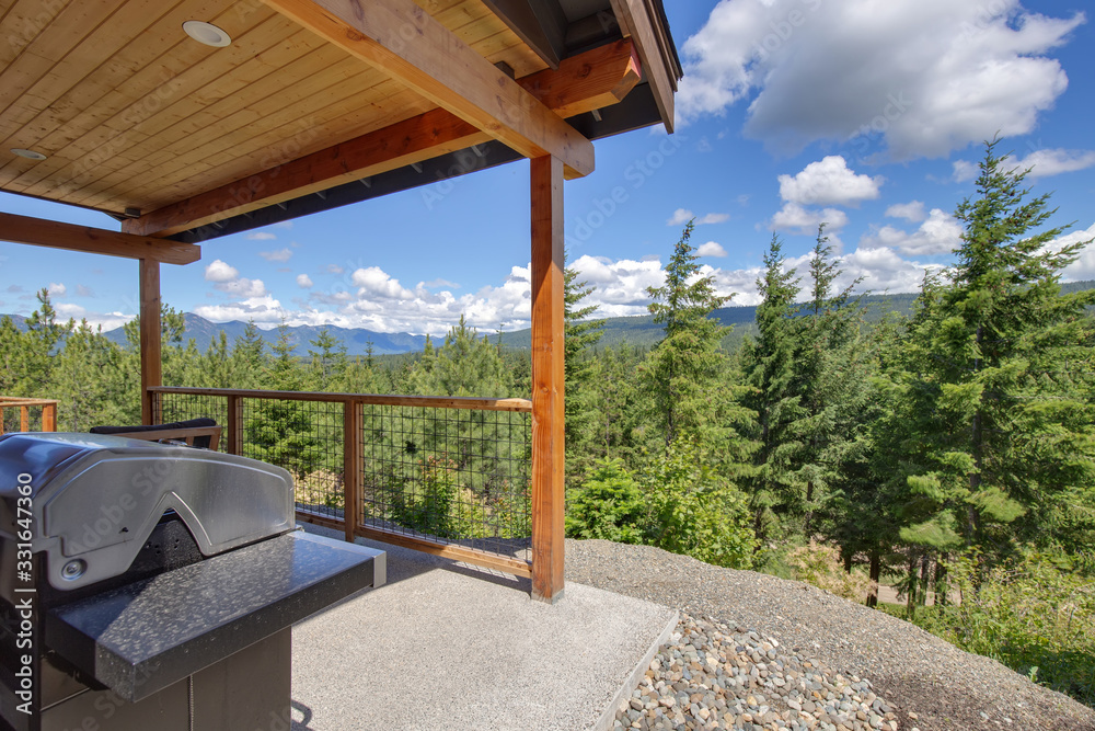 Amazing balcony patio with fire pit and forest and mountains view. Dream come true home exterior. New AMerican architecture. Comfortable and beautiful home details.