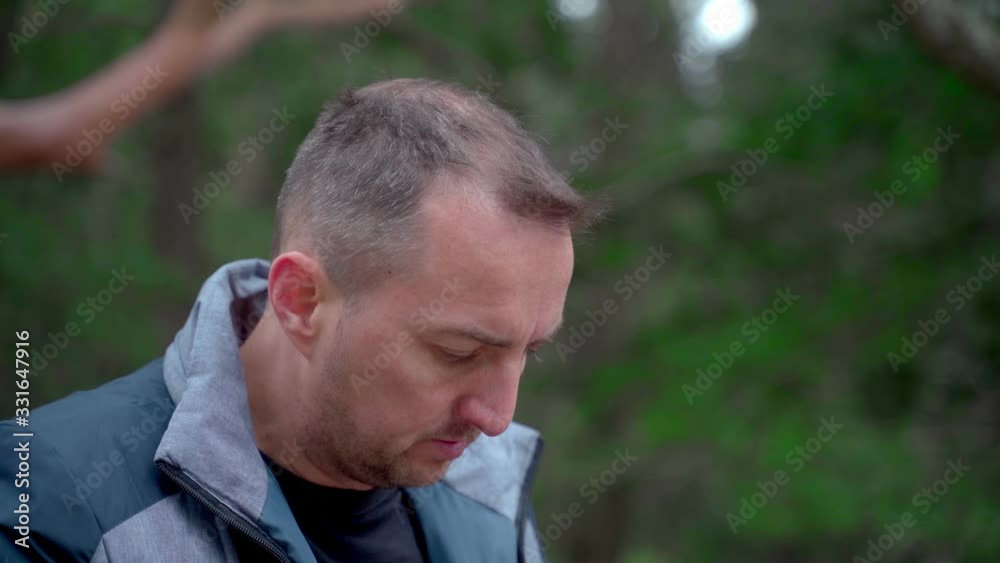 Closeup portrait of man with cleft lip coughs closing his mouth with his fist and wipes his nose with a handkerchief Closeup portrait of man with cleft lip coughs closing his mouth with his fist and wipes his nose with a handkerchief
