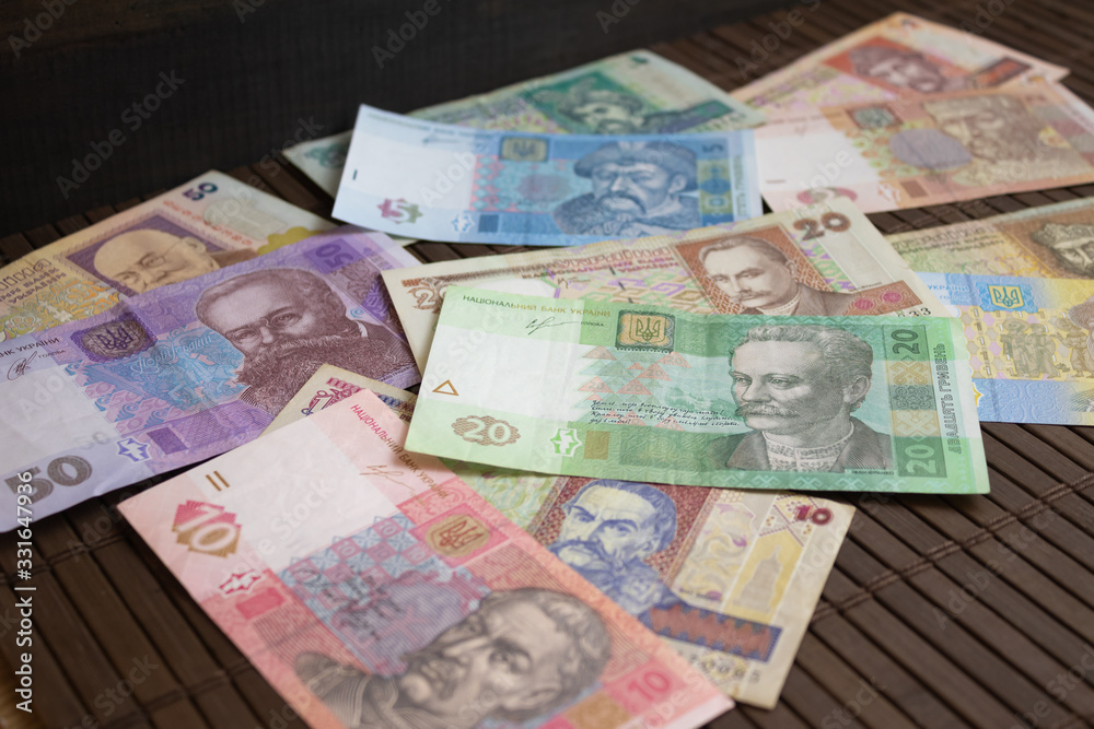 Fototapeta premium Paper money on a dark background. Ukrainian money, hryvnia.