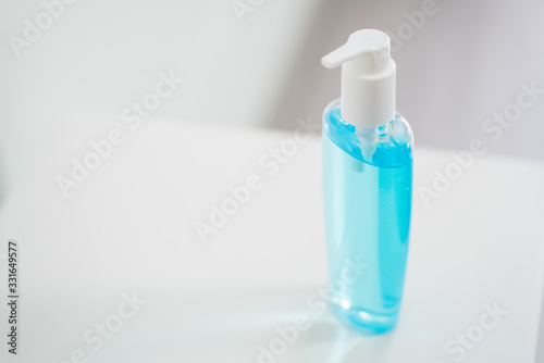 Close-up plastic bottle pump with alcohol hand gel. Coronavirus or covid 19 concept.