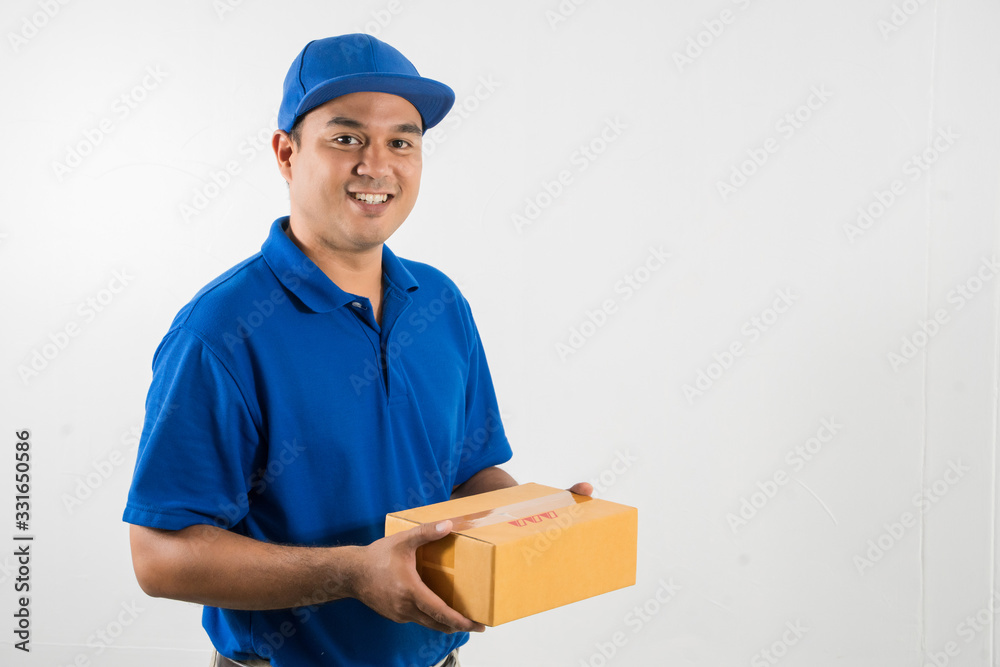 Blue Delivery handsome asian man holding parcel cardboard box on isolated white background.