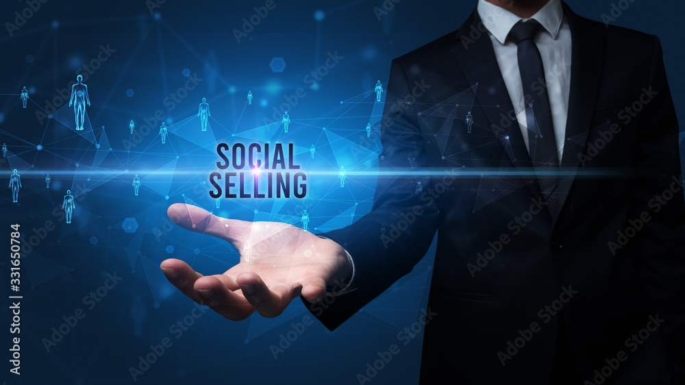 Elegant hand holding SOCIAL SELLING inscription, social networking concept Elegant hand holding SOCIAL SELLING inscription, social networking concept