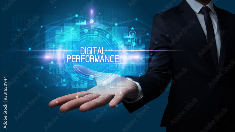 Man hand holding DIGITAL PERFORMANCE inscription, technology concept Man hand holding DIGITAL PERFORMANCE inscription, technology concept