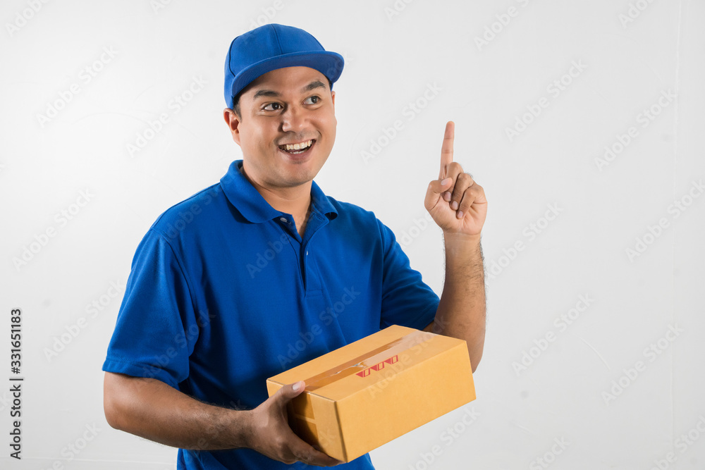 Blue Delivery handsome asian man holding parcel cardboard box on isolated white background. Blue Delivery handsome asian man holding parcel cardboard box on isolated white background.