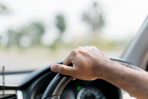 The hand is holding the steering wheel of the car Safe driving
