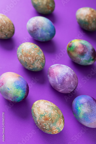 Colored easter eggs on a violet trend