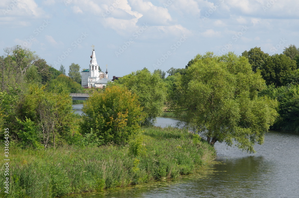 Summer landscape with a view of the Kamenka river and the Church of St. Nicholas. Suzdal, Vladimir region. Golden ring of Russia