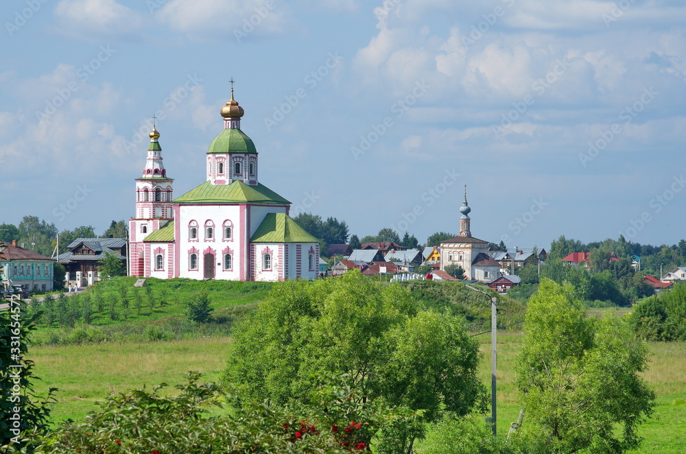 Summer view of the Church of Elijah the Prophet and the temple of the Tikhvin icon of the mother of God. City of Suzdal, Vladimir region. Golden ring of Russia