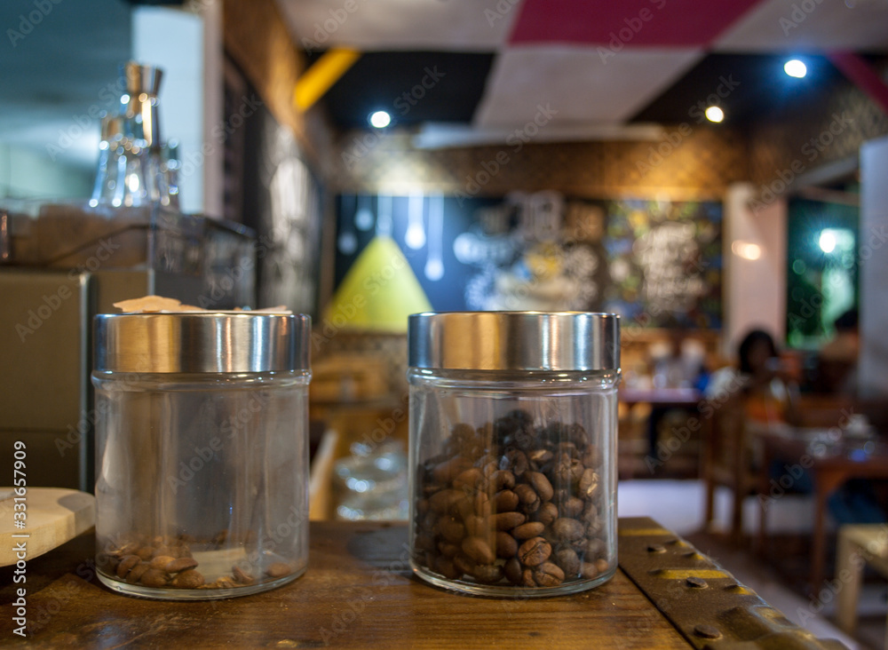 Coffee Beans in a Jar With a Cafe Background Coffee Beans in a Jar With a Cafe Background