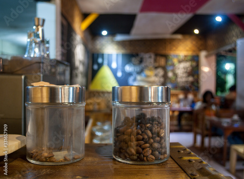 Coffee Beans in a Jar With a Cafe Background