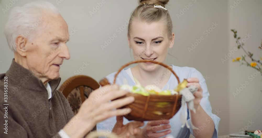 Woman Giving Easter Basket to Grandfather Woman Giving Easter Basket to Grandfather