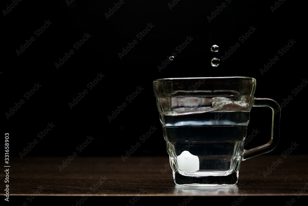 The water in the glass looks fresh and pure on the table.