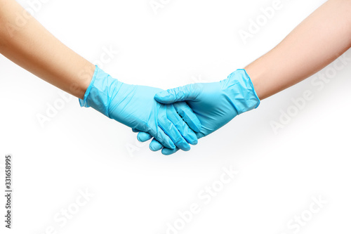 Handshake in blue medical gloves isolated on white background.