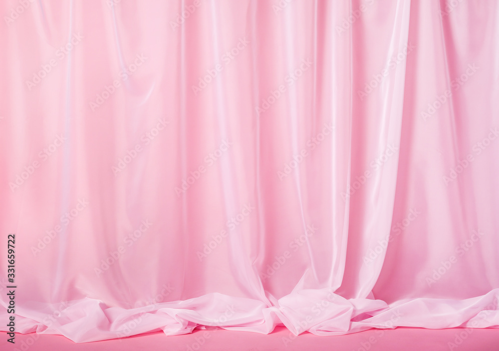 Tender pink silk curtains on pink background
