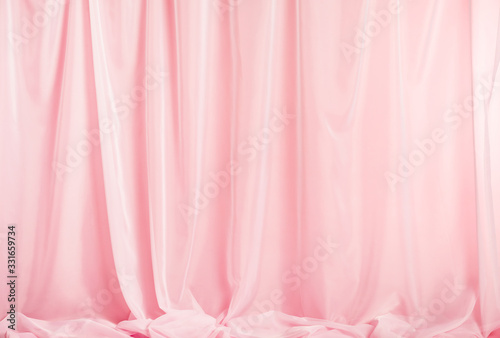 Tender pink silk curtains on pink background