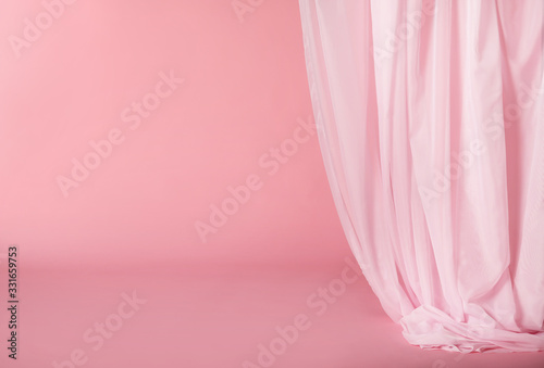 Tender pink silk curtain on pink background