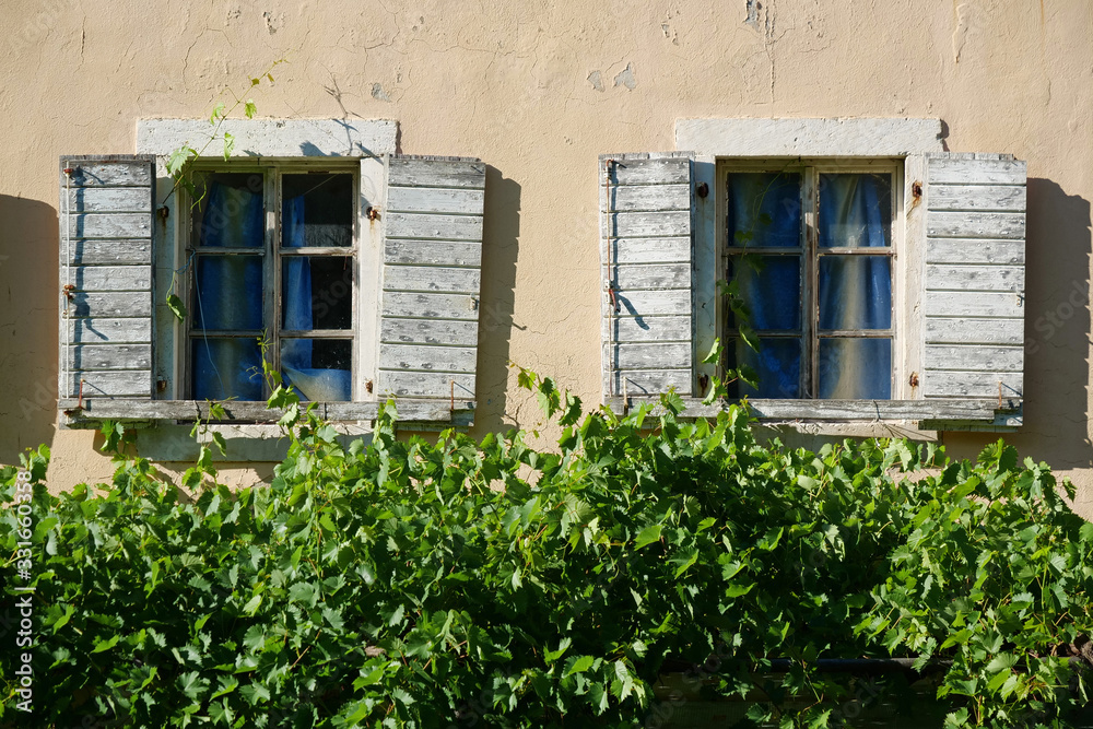 Windows with wooden shutters