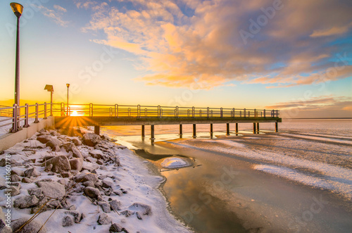 sunrise pier sea winter ice 