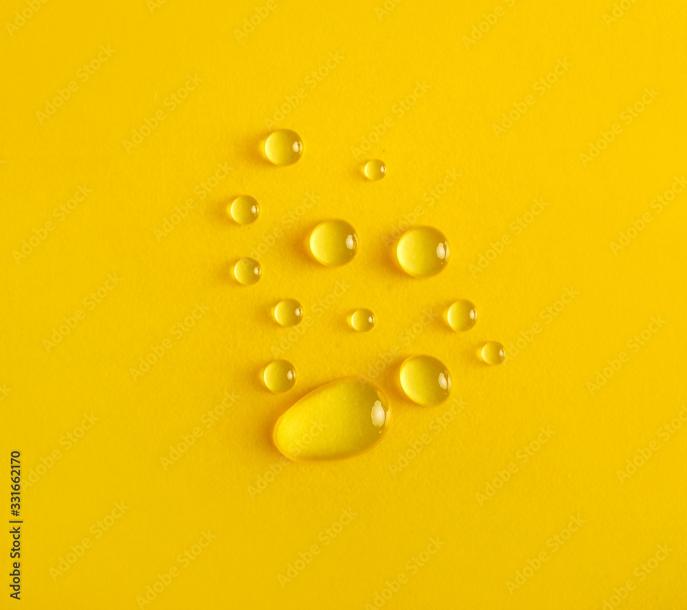 Water drops on yellow background