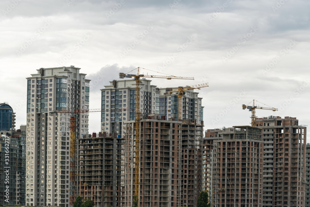 Buildings under construction. Lifting cranes
