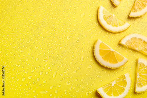Lemon slices on yellow background photo