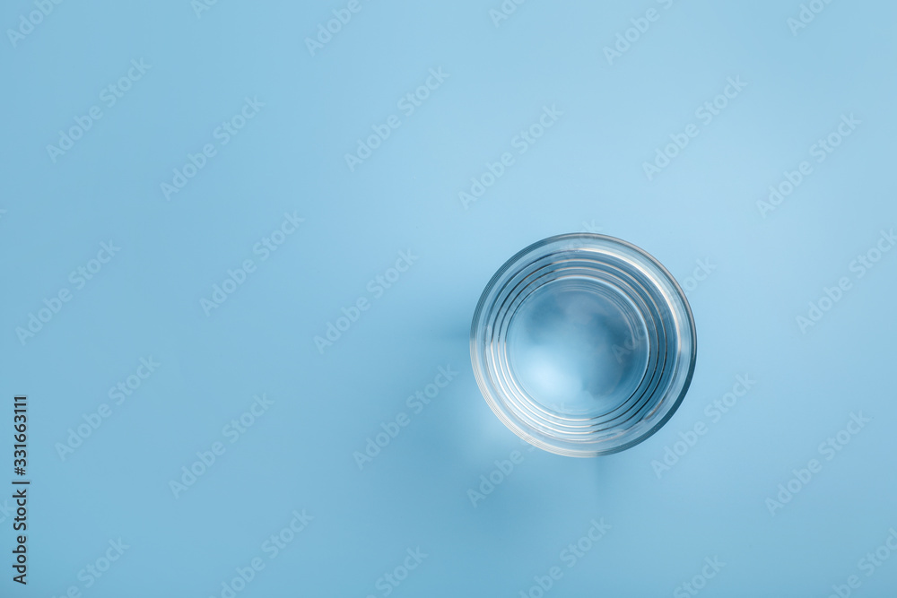 Top view of glass of water on blue background Top view of glass of water on blue background
