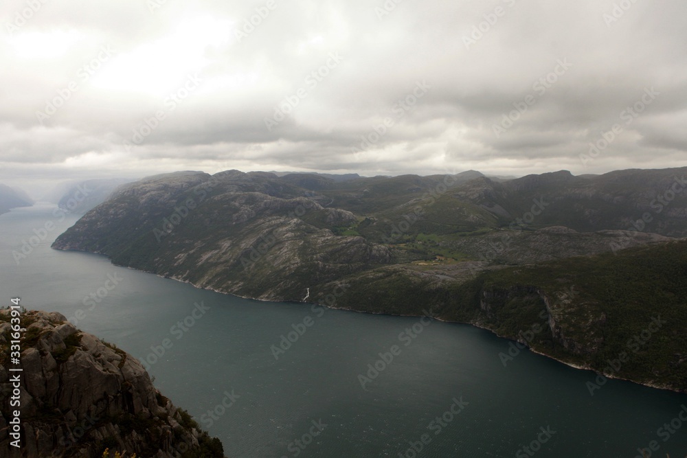 View from the Cliff Preikestolen in fjord Lysefjord - Norway - nature and travel background. Vacation concept. Granite rocks and mountains