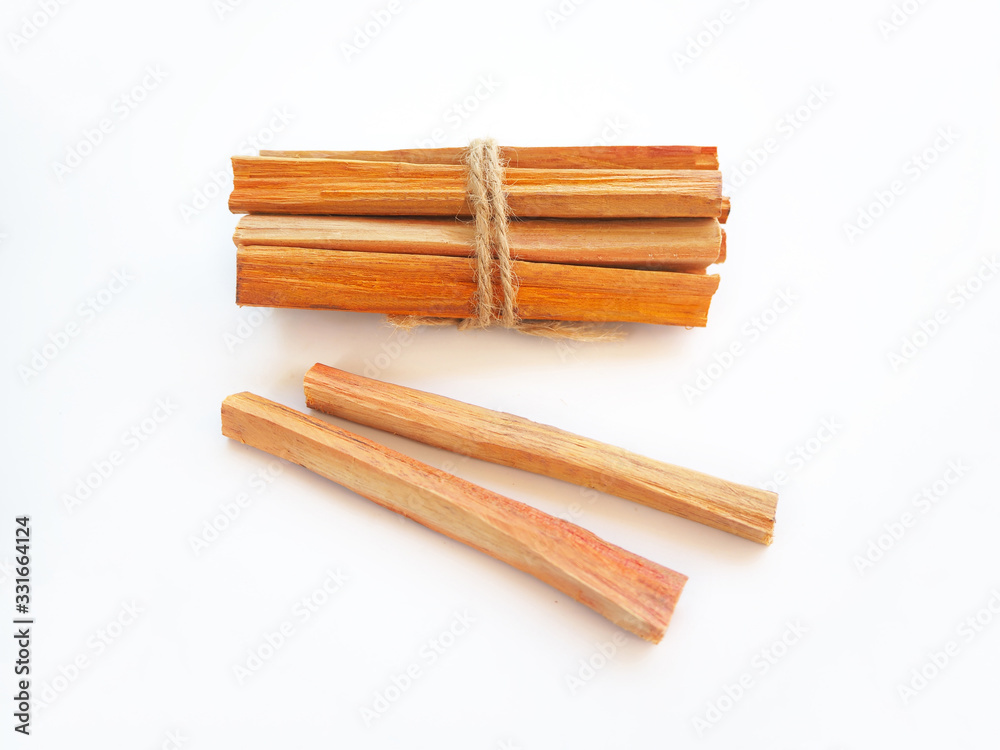 sappan wood or sappan tree on white background is a chinese herb and suitable to invigorate blood ,remove stagnation and lowers risk of heart disease use for herb tea product or health care concept. sappan wood or sappan tree on white background is a chinese herb and suitable to invigorate blood ,remove stagnation and lowers risk of heart disease use for herb tea product or health care concept.