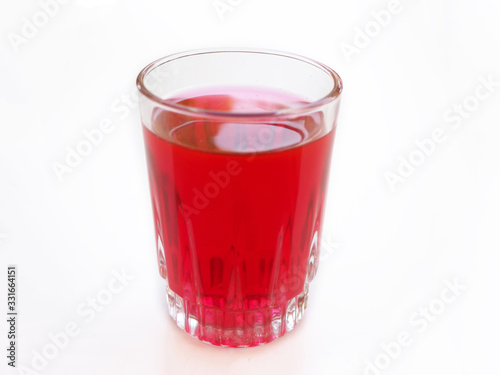 sappan water in glass on white background is a chinese herb and suitable to invigorate blood ,remove stagnation and lowers risk of heart disease use for herb tea product or health care concept.