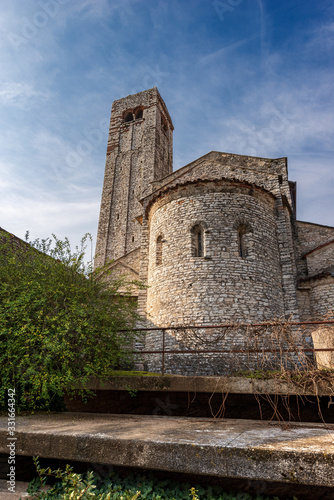 Ancient parish Church of San Giorgio di Valpolicella or Ingannapoltron in Romanesque style (VII - XI century), with the bell tower and apse. Veneto, Verona province, Italy, Europe