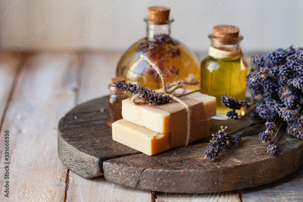 Concept of using natural organic oil in cosmetology. Moisturizing skin care and aromatherapy. Gentle body treatment. Handmade soap. Atmosphere of harmony, relax. Wooden background copy space for text Concept of using natural organic oil in cosmetology. Moisturizing skin care and aromatherapy. Gentle body treatment. Handmade soap. Atmosphere of harmony, relax. Wooden background copy space for text