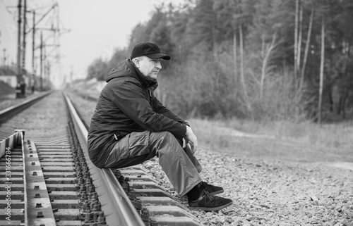 Mature senior man on Railway, don't joke with rails 