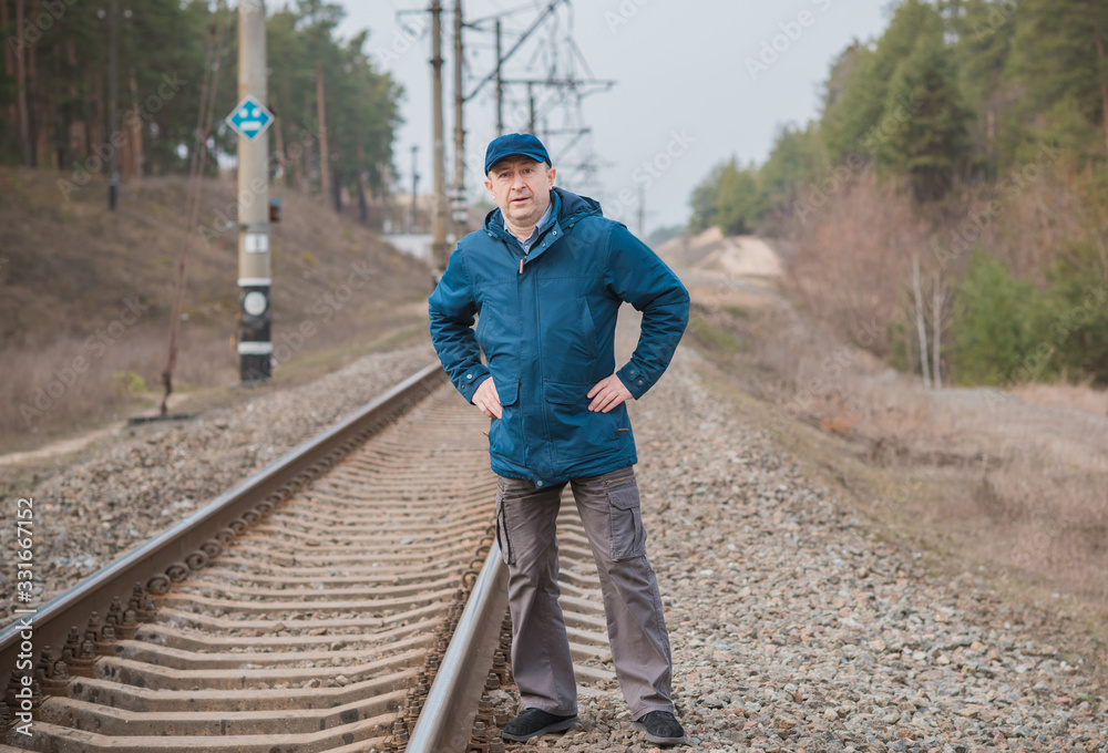 Senior man thinking about his life on Railway, Mature man psychology 