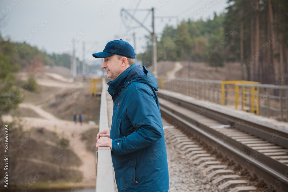 Senior man thinking about his life on Railway, Mature man psychology 