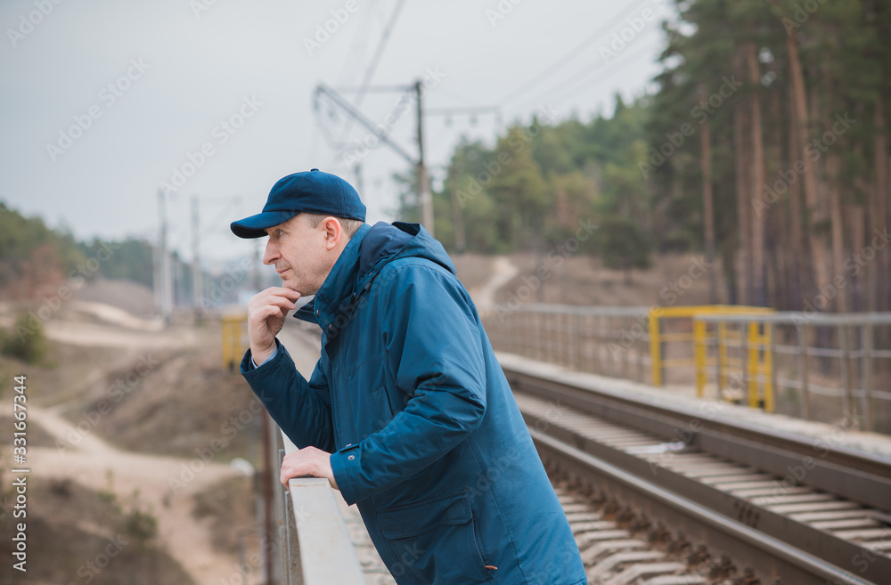 Senior man thinking about his life on Railway, Mature man psychology 