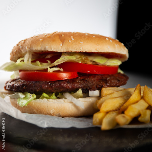 Tasty burger with tomatoes and lettuce