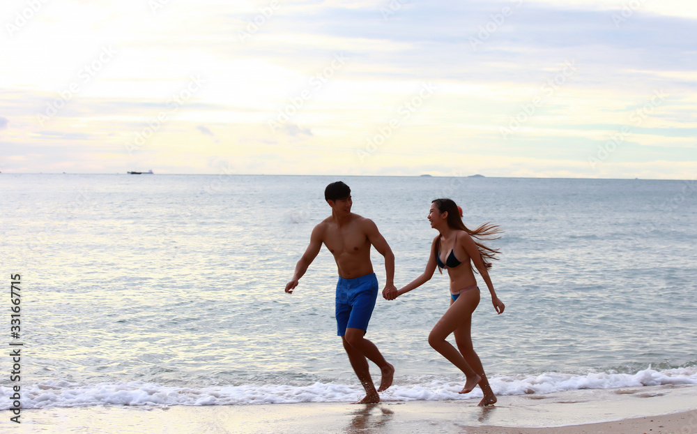 A couple play runing on beach 