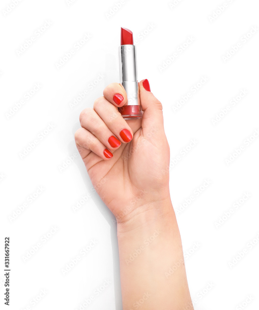 Hand with red manicure with red lipstick in hands isolated on white background Hand with red manicure with red lipstick in hands isolated on white background