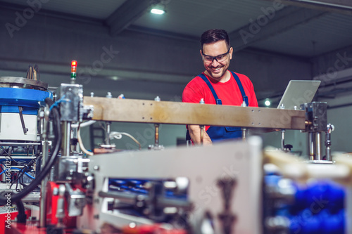 Industrial engineer with laptop in a  industrial manufacture factory working. photo