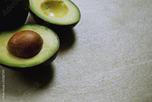 Fresh half avocado on stone table. Vegetarian food concept with copy space.