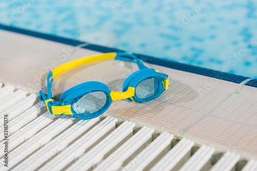 goggles near swimming pool with blue water