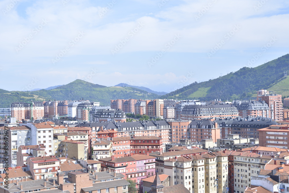Aerial view of Bilbao city with mounts at the background