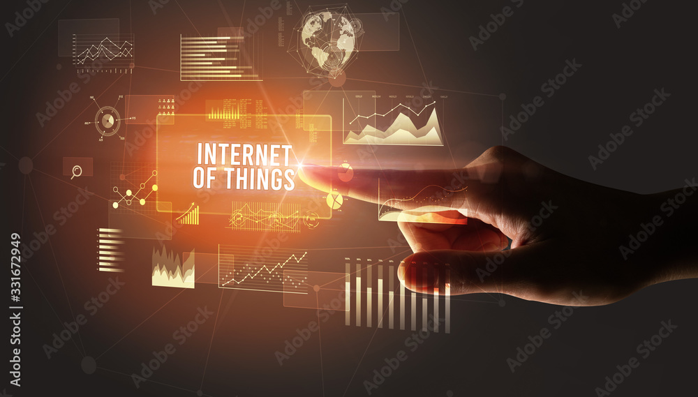 Hand touching INTERNET OF THINGS inscription, new business technology concept Hand touching INTERNET OF THINGS inscription, new business technology concept
