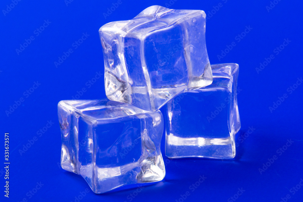 ice cubes in close-up on blue background ice cubes in close-up on blue background